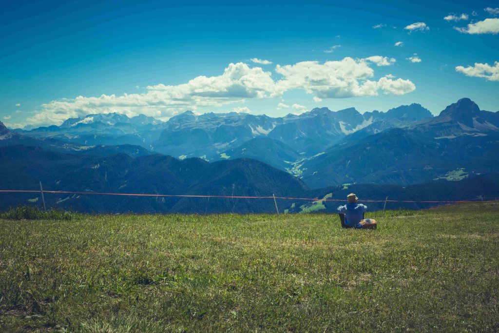 Man sitting in front of a blue sky